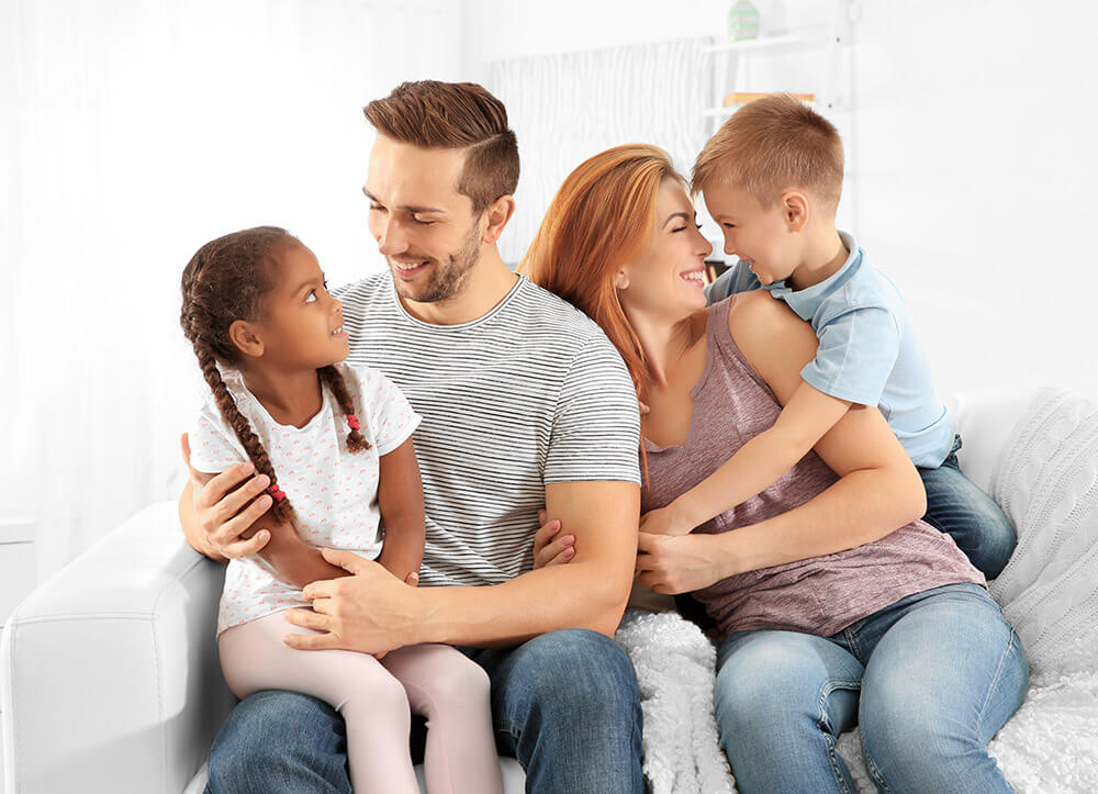 happy family sitting on sofa